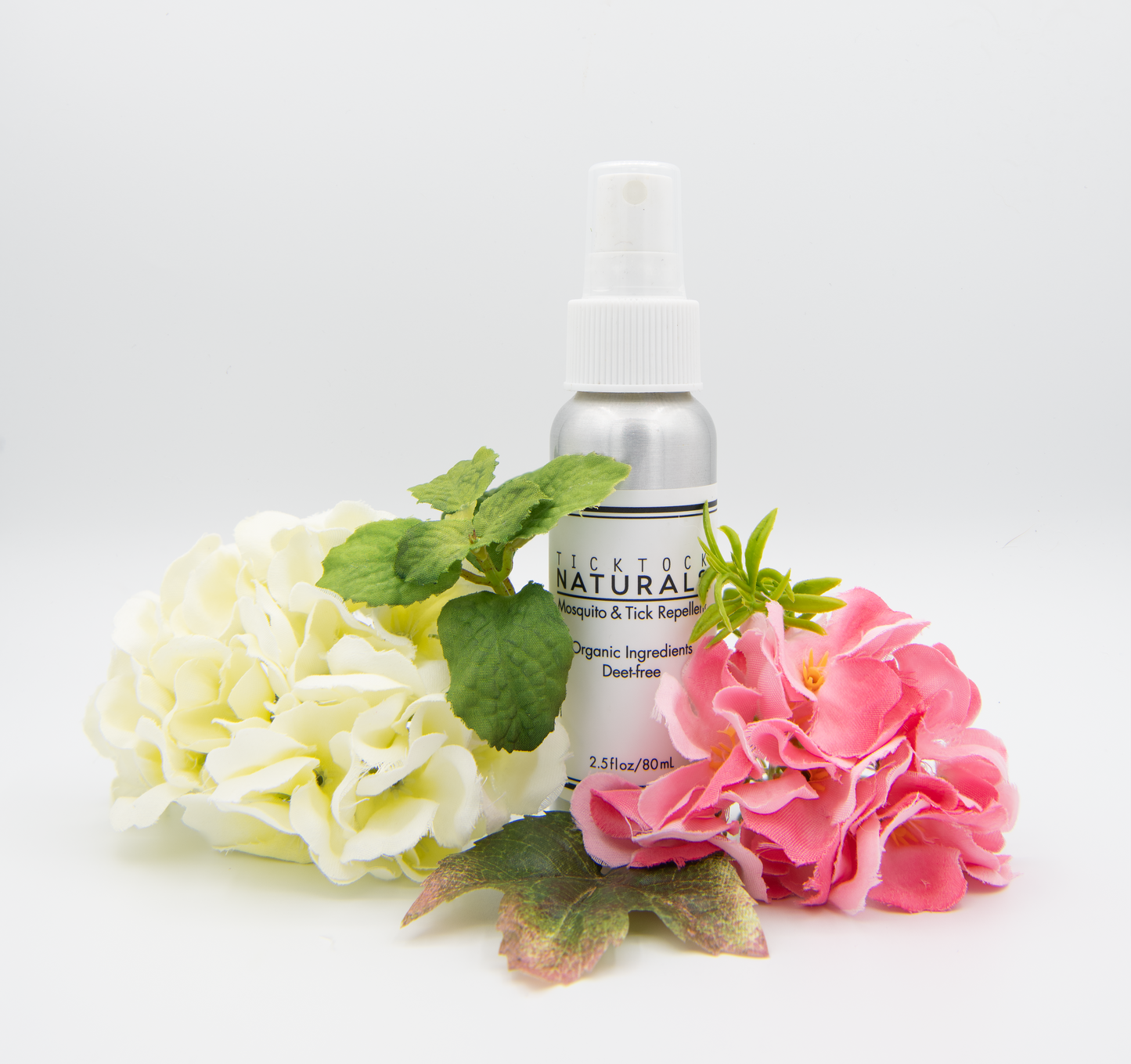 TickTock Naturals mosquito and tick repellant 2.5 fl oz bottle with flowers on a white background