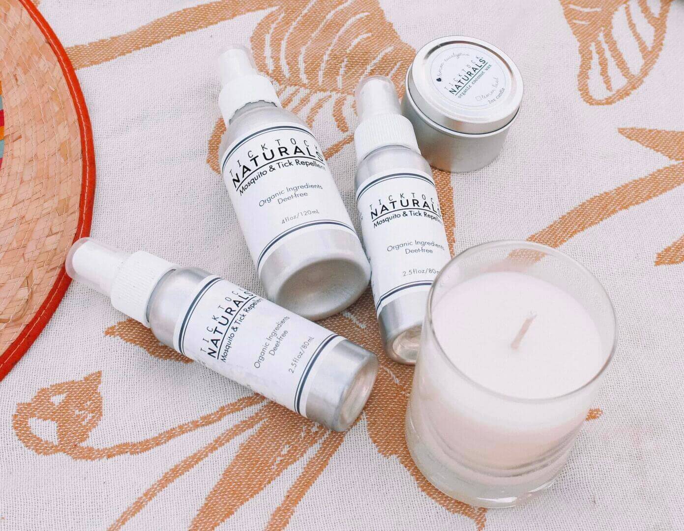 Tick Tock Naturals Product Line on a summer beach blanket.